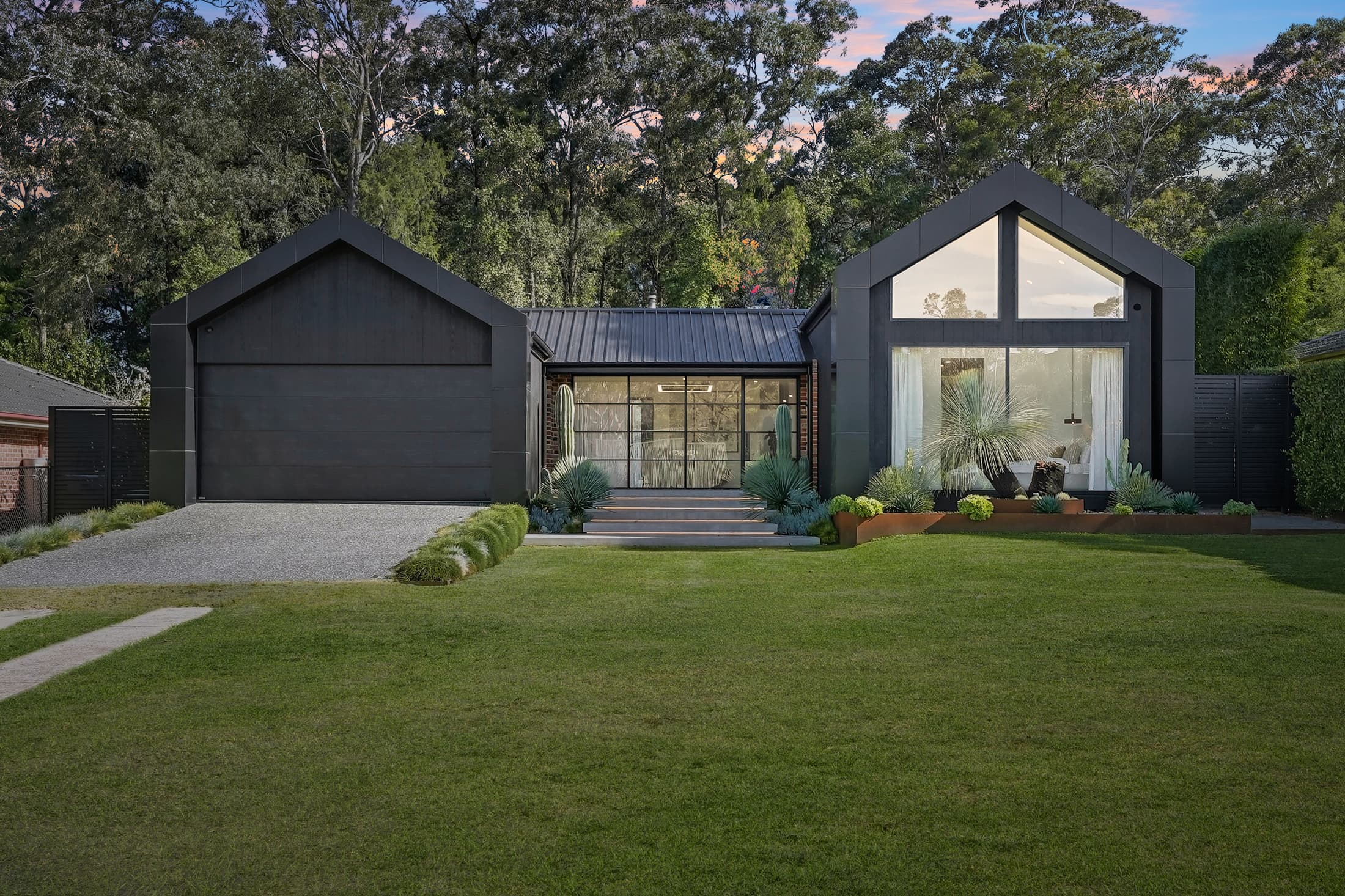 Barn-style home photographed at dusk