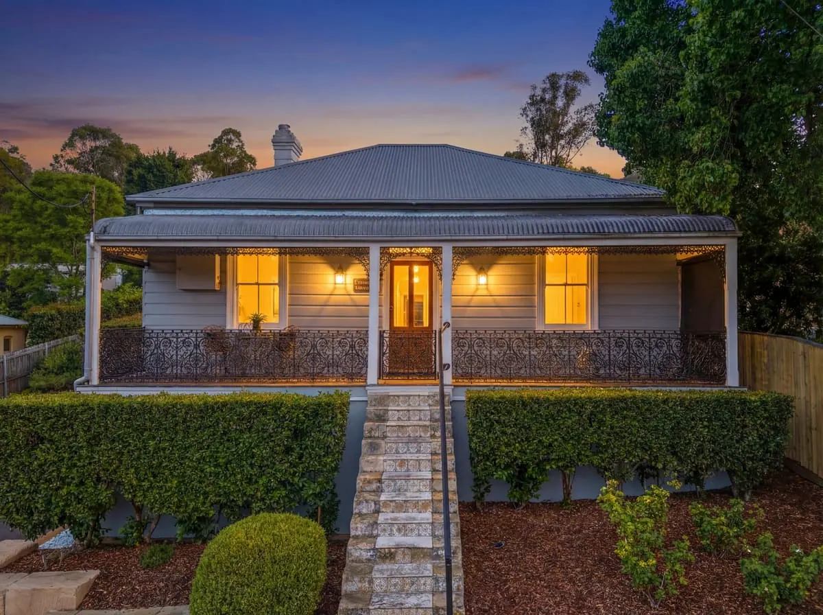 Heritage cottage at Picton at dusk, lights on