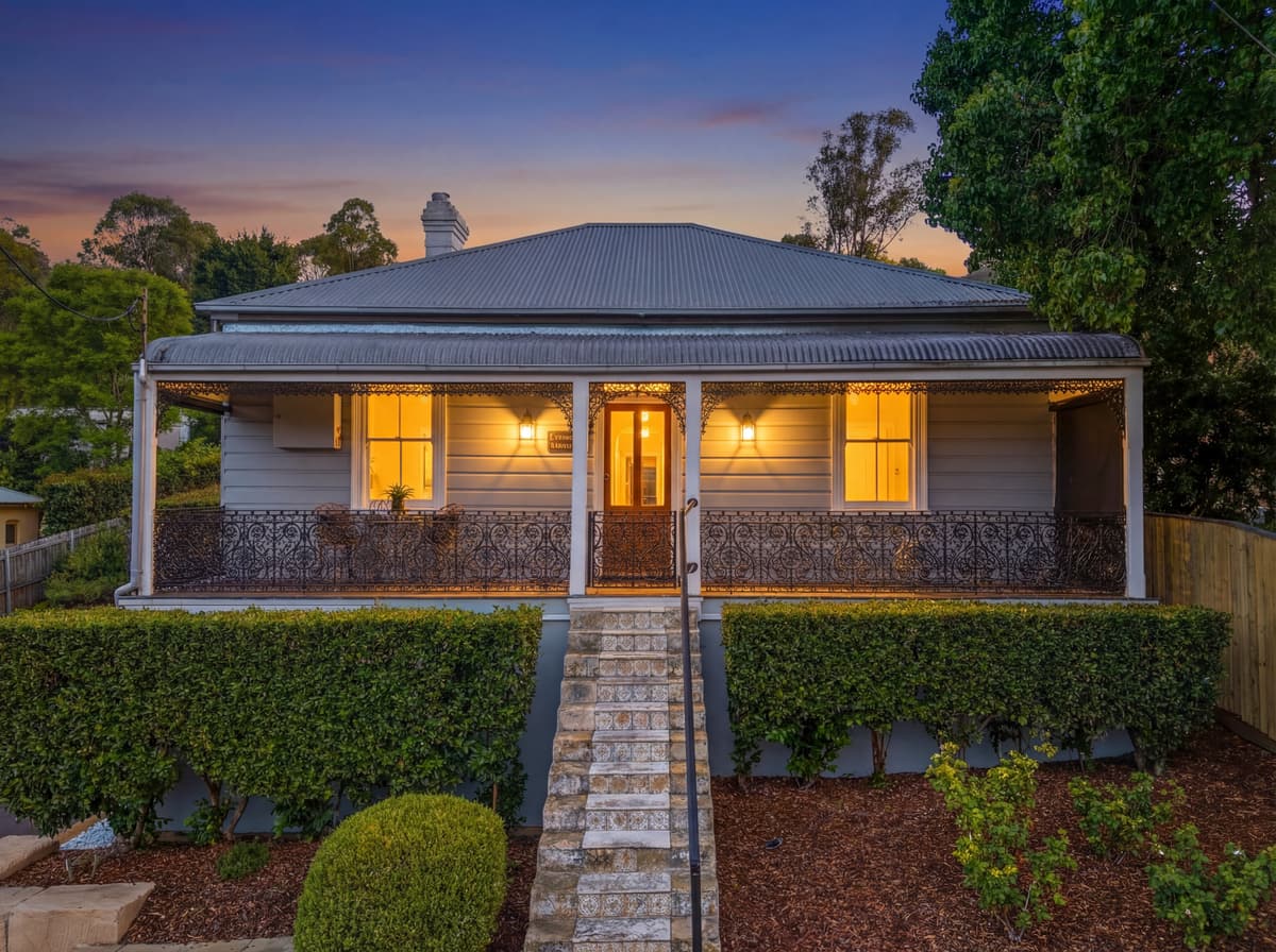 Heritage cottage at Picton at dusk, lights on